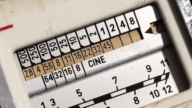 Vintage light meter numbers shift as knob turns back and forth