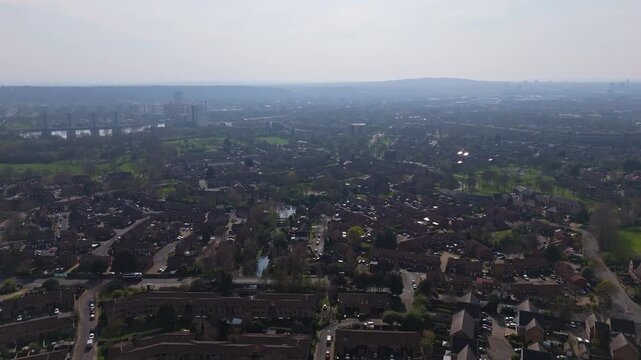 An establishing drone shot over a London Croydon suburb on a bright sunny day in Spring