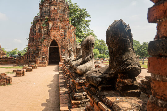 Ancient buddha is broken,old Buddha meditation, Buddha statue has destroy, no head Buddha statue. Buddha statue without head on brick wall of ancient Wat Mahathat, Ayutthaya province , Thailand.