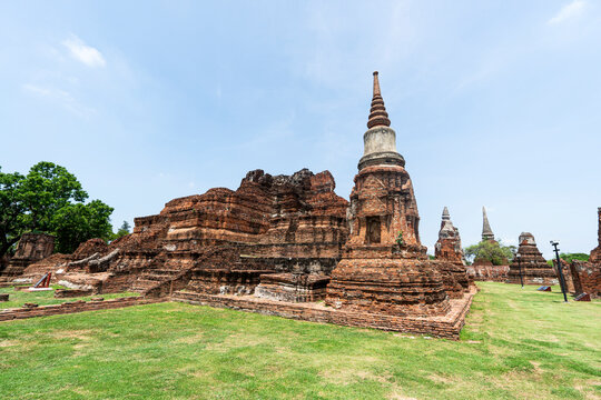 Ruins of ancient city temples Ayutthaya, Thailand. Old kingdom of Siam. Summer day with blue sky. Famous tourist destination, spiritual place near Bangkok.