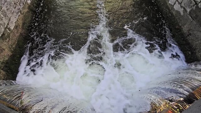 Locked-down video of the Grand Canal Lock, canal flowing closeup.