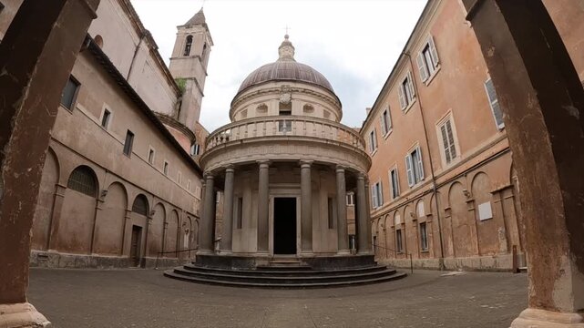 Stunning wide-angle view of Tempietto di Bramante, iconic Renaissance circular temple in Rome courtyard. Historic Italian architecture with classical columns and dome, surrounded by ancient buildings.