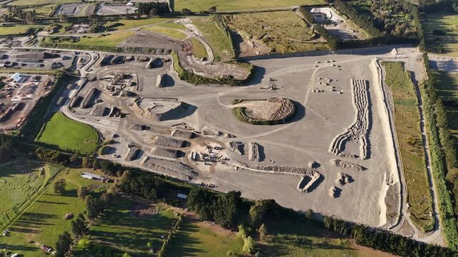 Smooth 4K 60FPS drone footage of a vast rock quarry in Sheffield, NZ. Captures industrial excavation, heavy machinery sites, and raw material extraction in the South Island landscape