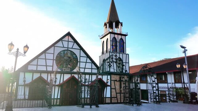iconic timber-framed church, showcasing its unique German-style architecture under a clear morning sky