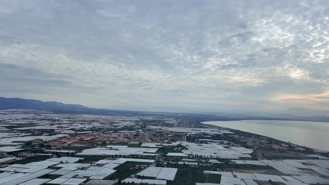 A pilot&rsquo;s eye view of the final approach to coastal Almeria aiport runway, flying over an extense aera of greenhouses, at the blue hour.