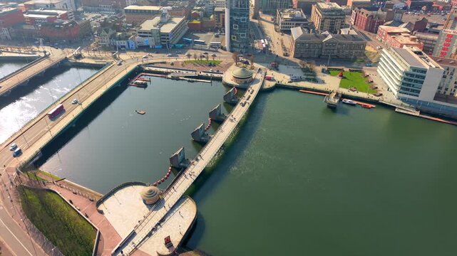 Clockwise 4K 60FPS aerial video of the River Lagan and Lagan Bridges in Belfast City Centre in Belfast, Northern Ireland. Produced in 3840x2160 ratio with Rec709 color.