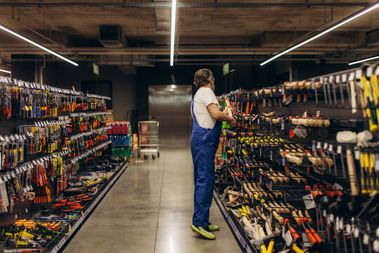 Man shopping tools in hardware store aisle
