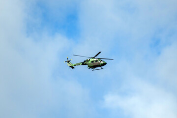 Fototapeta premium Helicopter formation against isolated cloudy mid sky