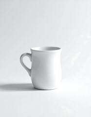 Obraz premium A white ceramic mug with a handle on a plain white background