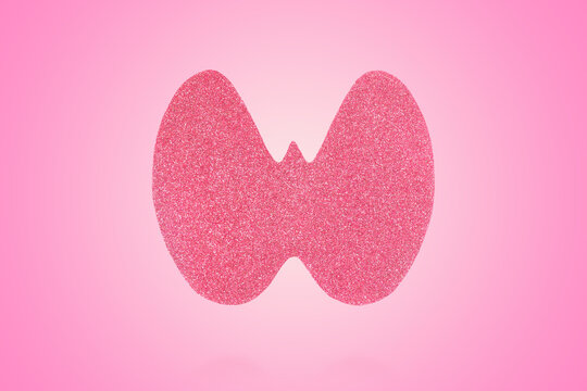 World Thyroid Day. Concept of thyroid disease and health. Pink Paper form of the thyroid gland on pink background
