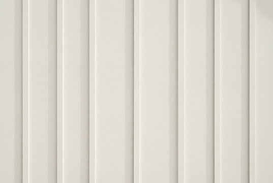 Clean minimalist background of off white vertical board and batten wall siding