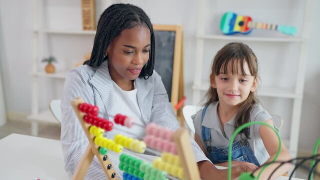 African tutor use educational toy help little child learn basic skills. 