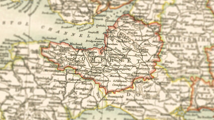 Macro close up of a vintage map highlighting Somerset in the United Kingdom, showcasing detailed cartography, major towns, and classic antique textures ideal for travel, geography, and historical them © Andi Permana