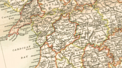 Fototapeta premium Macro View of Vintage Map Highlighting Montgomeryshire Wales with Detailed Regional Cartography