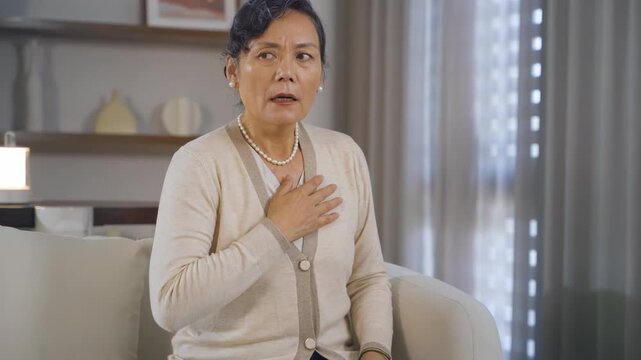 Fatigue old woman hands massage chest pain suffering with heart disease attack, anxiety, asthma, cardiac arrest, stress or stroke, breathing issue in health risk, medical emergency and heartburn