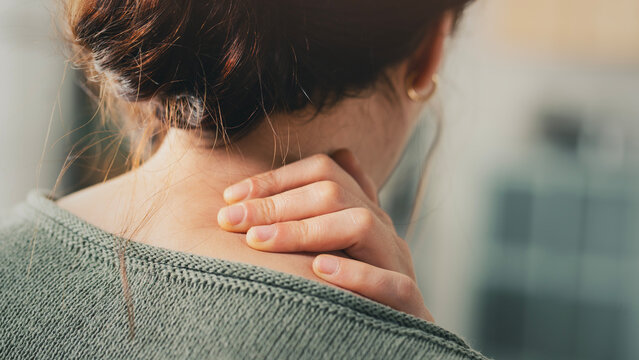Young woman suffering from nape pain