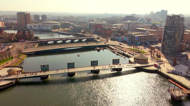 Rising 4K 60FPS aerial video of the River Lagan and Lagan Bridges in Belfast City Centre in Belfast, Northern Ireland. Produced in 3840x2160 ratio with Rec709 color.