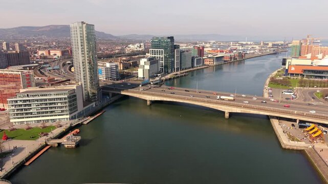 Passing overhead 4K 60FPS aerial video of the River Lagan and Lagan Bridges in Belfast City Centre in Belfast, Northern Ireland. Produced in 3840x2160 ratio with Rec709 color.