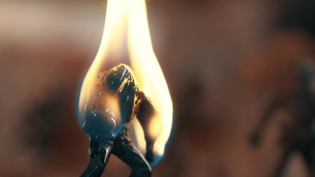 Close up of a green plastic toy soldier burning and melting. Conceptual video about the horrors and consequences of war and conflict