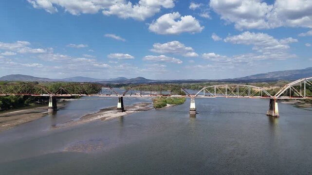 Aerial view of Historic railway bridge over Lempa River in San Marcos Lempa, El Salvador, infrastructure heritage