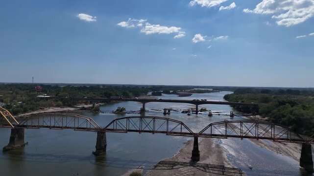 Historic railway bridge and modern San Marcos Lempa bridge over Lempa River, El Salvador, infrastructure