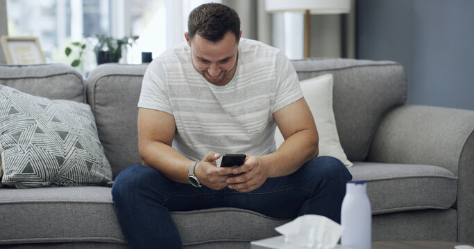 Man, smile and scroll in living room with phone, download app and search website for pornography. Happy, male person and lotion in house with tissue, digital tech or browsing online for masturbation.