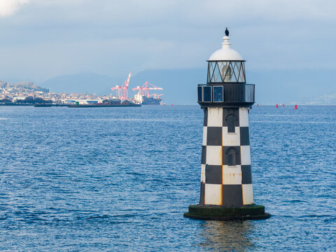 Greenock Lighthouse Scotland on the River Clyde. Maritime Beacon and Calm Coastal Waters create scenic Scottish waterfront view.
