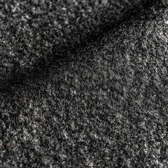 Fototapeta premium Gray wool fabric close-up showing texture and fibers in natural light during the day