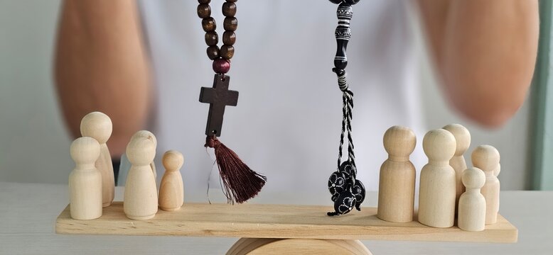 Balancing faith and community values through wooden figures and prayer