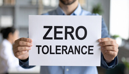 Business professional holding sign zero tolerance. Workplace safety, harassment and violence. Serious tone, corporate ethics