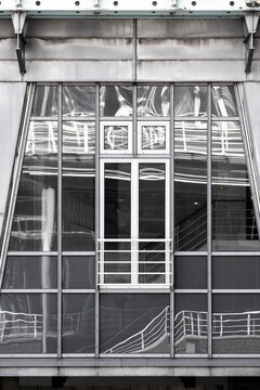 Monochrome urban industrial structure with glass window on an architectural facade delivering pattern and geometry in bold abstract contrast