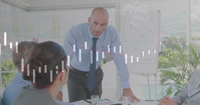 Presenter rising and leaning on desk, stressing key data while overlaying market chart around table