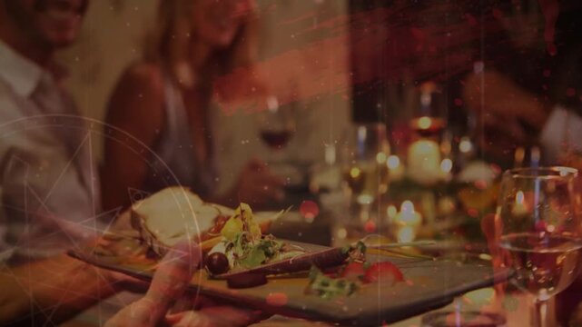 Server carrying wooden board toward dining table, diners reaching, taking appetizers, sharing meal