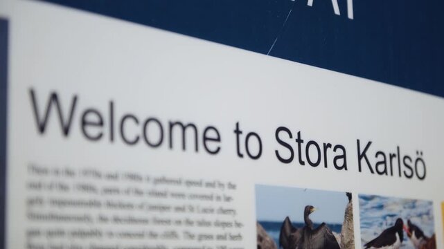 Close-up focus shift on welcome sign at Stora Karls&ouml; nature reserve, Gotland Sweden Baltic Sea