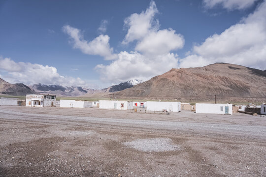 Local huts in the highland village of Murghab in Tajikistan in the Pamirs, highlanders' houses against the backdrop of mountains and rocky peaks