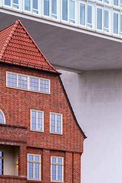 Urban architecture detail of a brick red building with facade windows and gable creating bold contrast in Hamburg Germany under clear daylight