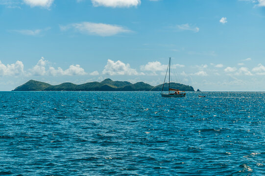 A view sailing past Cooper Island in the british virgin islands on a bright morning
