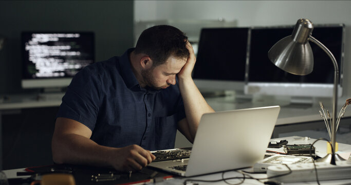 Stress, man and programming with laptop at office for coding error, data loss and software crash. Frustrated, male person and troubleshooting pc with broken tech, system overload and technical issues