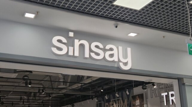 Vilnius Lithuania 25.03.2026 Sinsay clothing store sign with illuminated white logo above entrance in modern shopping mall interior representing fashion retail brand and stylish apparel shop