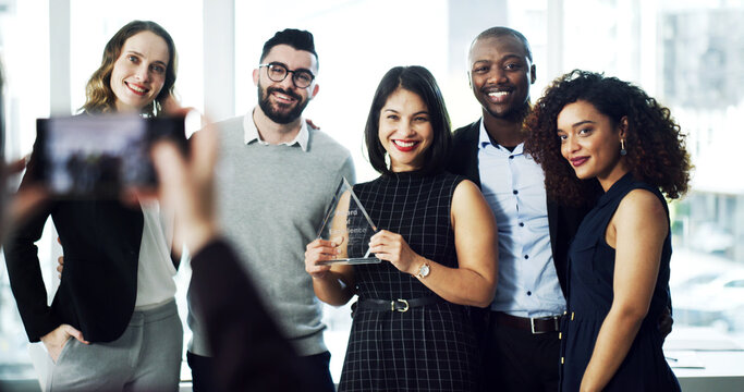 Woman, team and photo with trophy at office for goals, achievement and support at legal advisory agency. People, group and profile picture with celebration, award and diversity at corporate law firm
