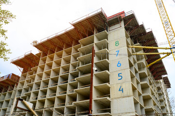 High rise concrete building frame construction site with tower crane. © Anna