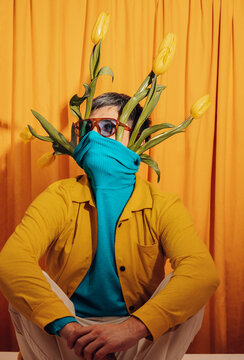 Man in colorful outfit with tulips as whimsical spring inspiration