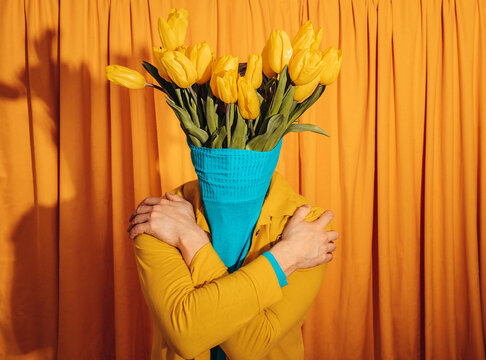 Whimsical portrait with tulip bouquet as head and crossed arms