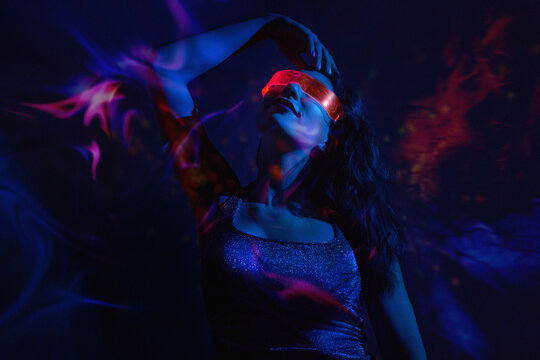 Dancing in neon lights with VR set at nightclub in virtual reality