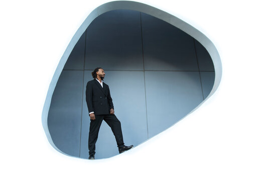 Businessman in suit standing in architectural opening in Barcelona