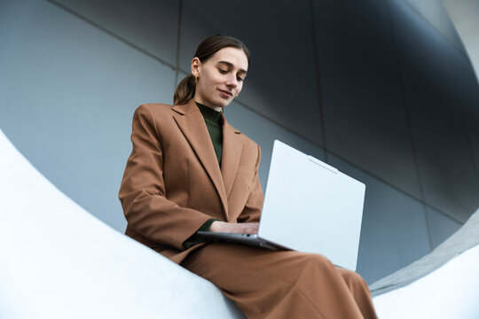 Businesswoman working on laptop outdoors in Barcelona