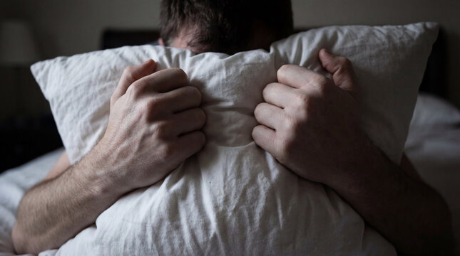 Stressed hands gripping soft white pillow tight panic relief