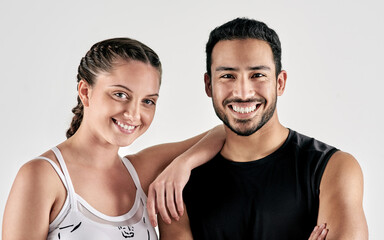 Obraz premium Couple, fitness and portrait with smile in studio for exercise support, self improvement and health. Active, relationship and athletes on white background for workout partner, wellness and confidence
