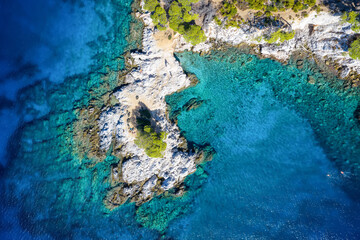 erial overhead of the beautiful Amarantos Cape and bay with Pine Trees and turquoise sea, Skopelos...