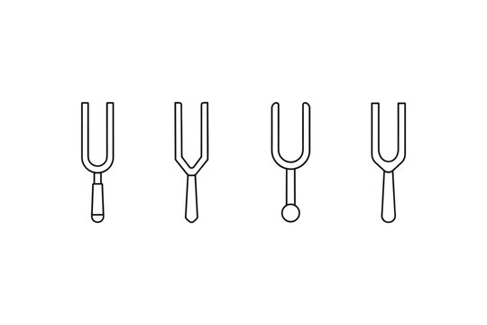 Set of four tuning forks with different handle designs on a white background